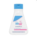 Sebamed baby shampoo bottle with blue cap on a white background