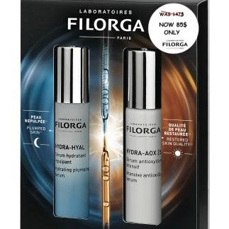 Filorga skincare product set with two bottles and a dropper in front of the brand's packaging.